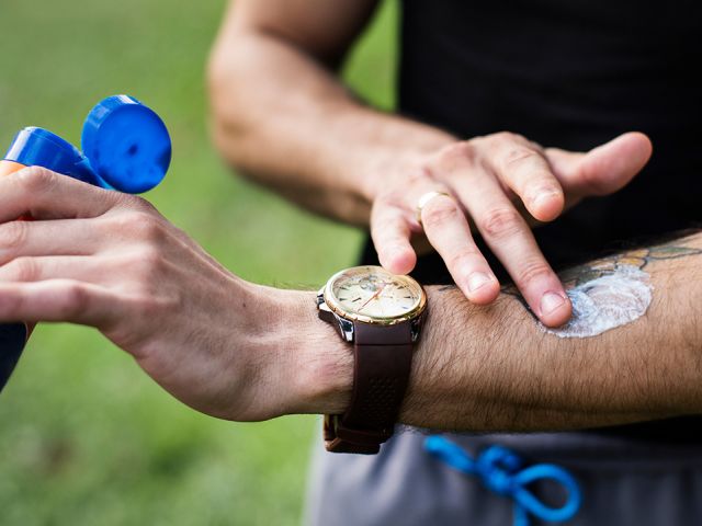 Person applying sunscreen