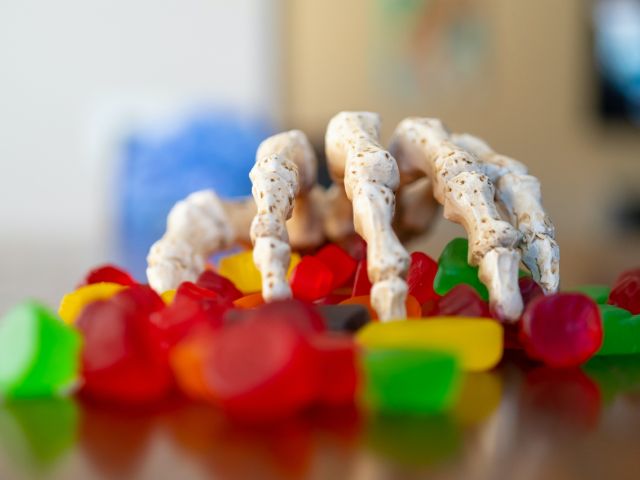 Skeleton hand reaching for candy