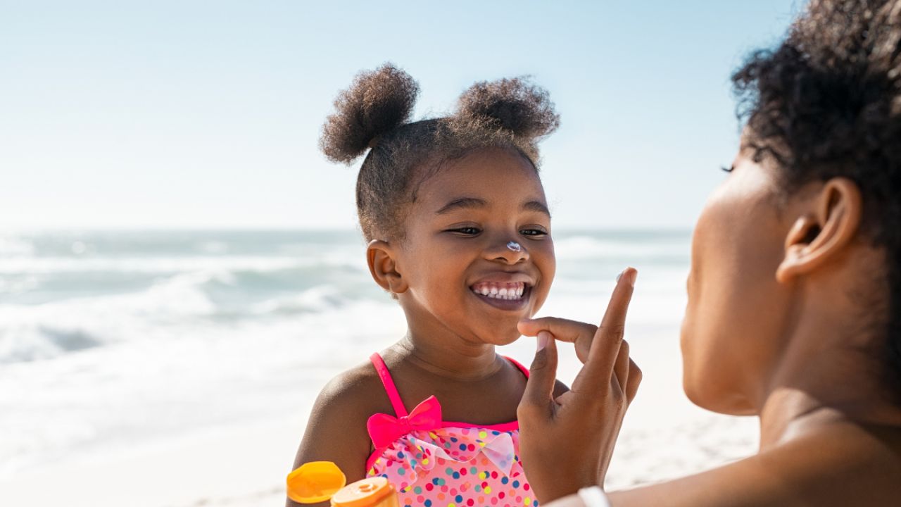 Applying sunscreen to a child