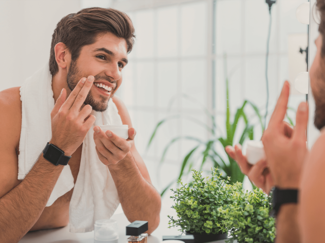 Man adding lotion to beard